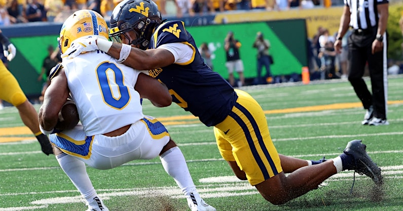 West Virginia defensive back Michael Coats makes the tackle against Pitt