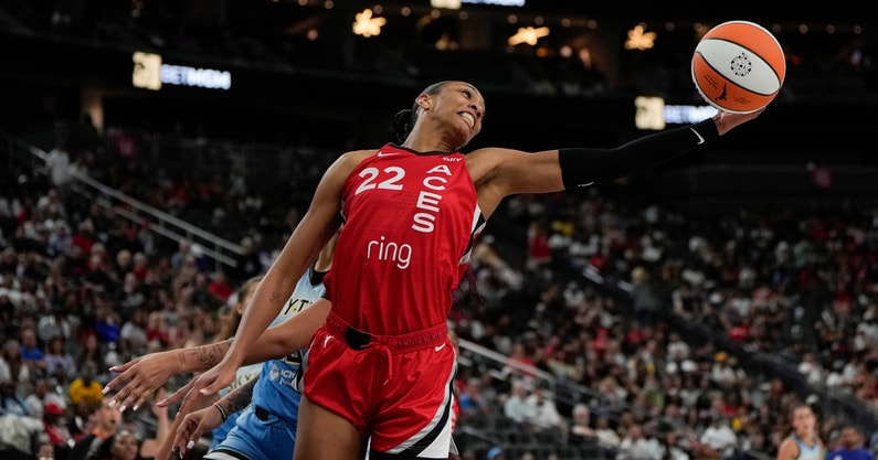 Las Vegas Aces center A'ja Wilson (22) reaches for the ball during the second half of a WNBA basketball game against Chicago Sky at T-Mobile Arena. Mandatory Credit: Lucas Peltier-Imagn Images