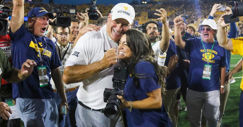 West Virginia head coach Rich Rodriguez celebates the win over Pitt with daughter Raquel