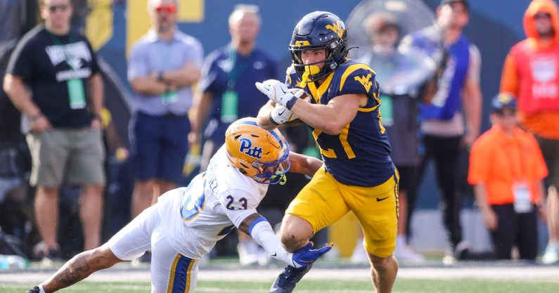 West Virginia Mountaineers running back Clay Ash breaks the tackle against Pitt