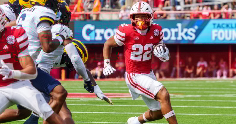 Nebraska football RB Isaiah Mozee looks for room against the Michigan defense