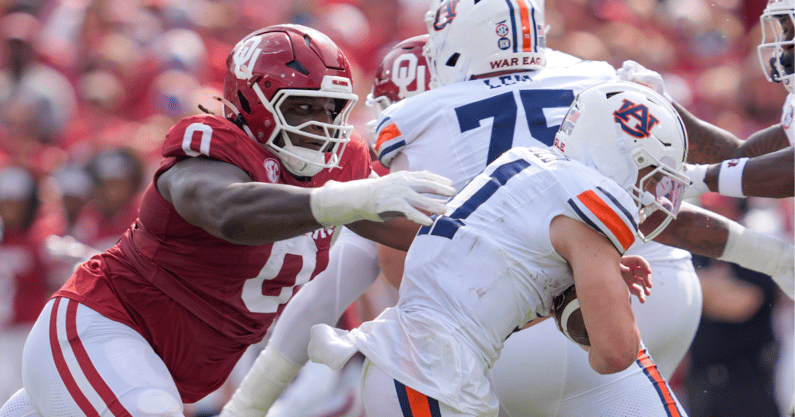 Jackson Arnold is sacked by Oklahoma's defense. (Photo by USA Today)