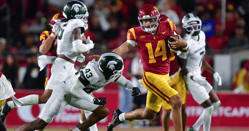 USC Trojans quarterback Jayden Maiava (14) runs the ball against Michigan State Spartans defensive back Malik Spencer (43) during the second half at the Los Angeles Memorial Coliseum