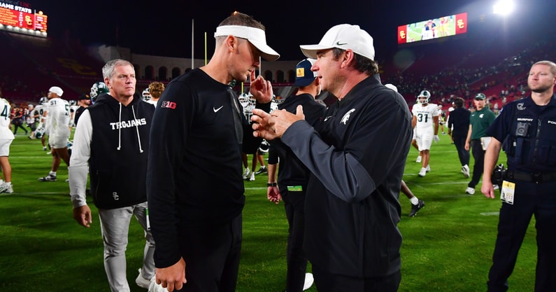 USC Trojans head coach Lincoln Riley meets with Michigan State Spartans head coach Jonathan Smith following the game at the Los Angeles Memorial Coliseum