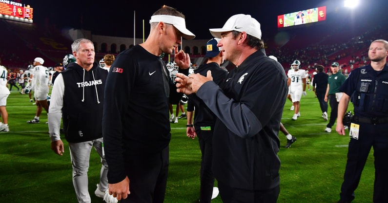 Southern California Trojans head coach Lincoln Riley meets with Michigan State Spartans head coach Jonathan Smith following the game at the Los Angeles Memorial Coliseum. - Gary A. Vasquez, USA TODAY Sports