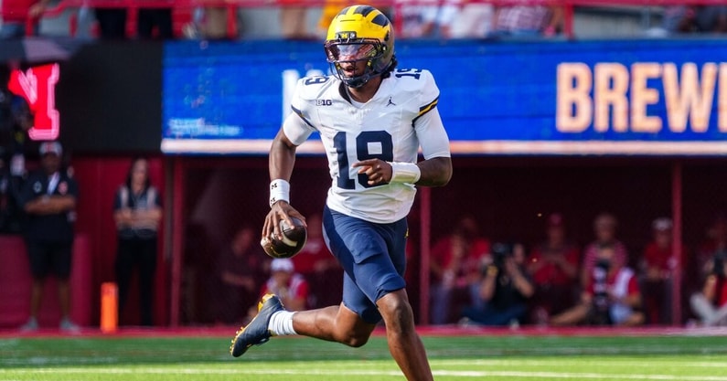 Sep 20, 2025; Lincoln, Nebraska, USA; Michigan Wolverines quarterback Bryce Underwood (19) scrambles against the Nebraska Cornhuskers during the third quarter at Memorial Stadium. Mandatory Credit: Dylan Widger-Imagn Images