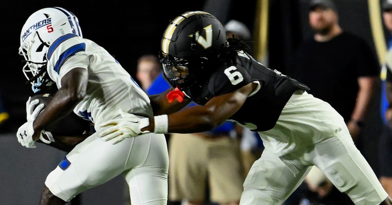 Sep 20, 2025; Nashville, Tennessee, USA;  Vanderbilt Commodores cornerback Jordan Matthews (6) tackles Georgia State Panthers wide receiver Javon Robinson (5) for a loss during the first half at FirstBank Stadium. Mandatory Credit: Steve Roberts-Imagn Images