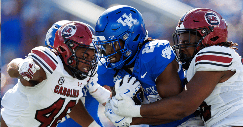 Sep 7, 2024; Lexington, Kentucky, USA; Kentucky Wildcats running back Jason Patterson (26) runs the ball through South Carolina Gamecocks defenders during the second quarter at Kroger Field. Mandatory Credit: Jordan Prather-Imagn Images
