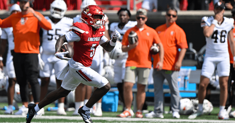 Sep 20, 2025; Louisville, Kentucky, USA; Louisville Cardinals wide receiver Caullin Lacy (5) runs the ball for a touchdown against the Bowling Green Falcons during the first half at L&N Federal Credit Union Stadium. Mandatory Credit: Jamie Rhodes-Imagn Images