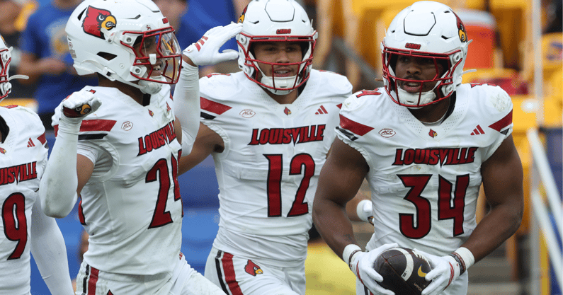 Sep 27, 2025; Pittsburgh, Pennsylvania, USA; Louisville Cardinals defensive back Corey Gordon (24) and linebacker Kalib Perry (12) celebrate an interception by linebacker TJ Quinn (34) against the Pittsburgh Panthers during the fourth quarter at Acrisure Stadium. Mandatory Credit: Charles LeClaire-Imagn Images
