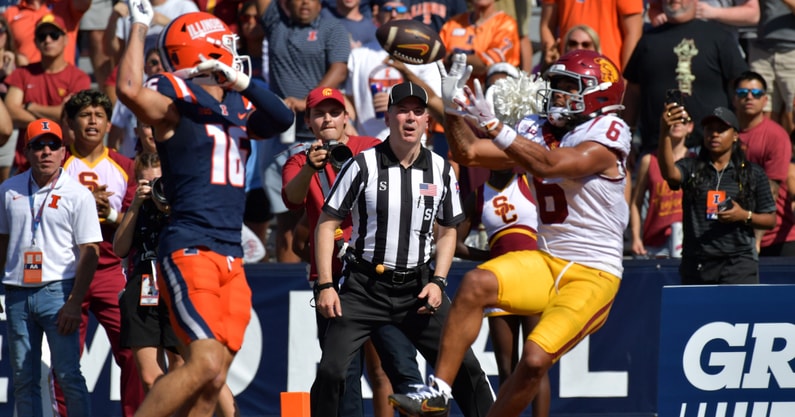 USC Trojans wide receiver Makai Lemon (6) scores a touchdown on a pass from quarterback Jayden Maiava (14) as Illinois Fighting Illini defensive back Tanner Heckel (16) defends during the second half at Memorial Stadium