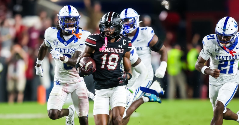 Kentucky defenders try to chase down South Carolina's Vandrevius Jacobs, via Jeff Blake, Imagn Images