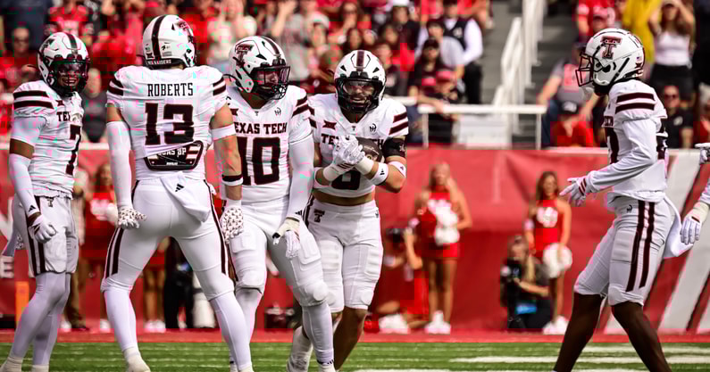 Texas Tech LB Ben Roberts punches out a ball as LB John Curry recovers it