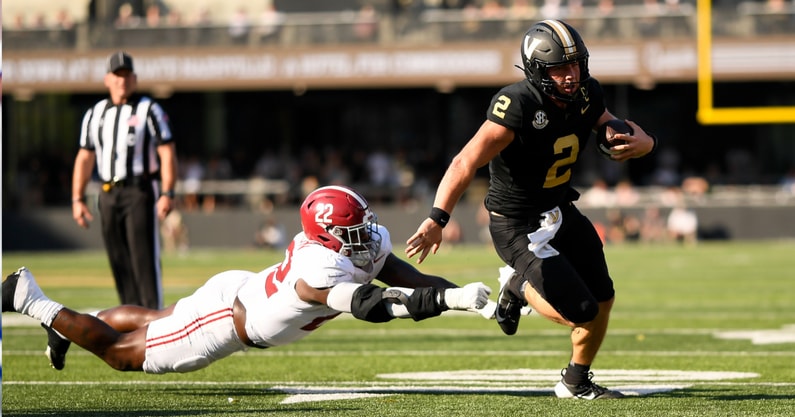 Oct 5, 2024; Nashville, Tennessee, USA; Vanderbilt Commodores quarterback Diego Pavia (2) breaks the tackle of Alabama Crimson Tide defensive lineman LT Overton (22) during the first half at FirstBank Stadium. Mandatory Credit: Steve Roberts-Imagn Images
