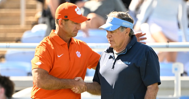 UNC coach Bill Belichick and Clemson coach Dabo Swinney meet in the pregame on Saturday.