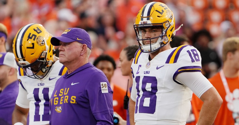 Aug 30, 2025; Clemson, South Carolina, USA; LSU Tigers head coach Brian Kelly and quarterback Garrett Nussmeier (18) look on during warmups before the game against the Clemson Tigers at Memorial Stadium.