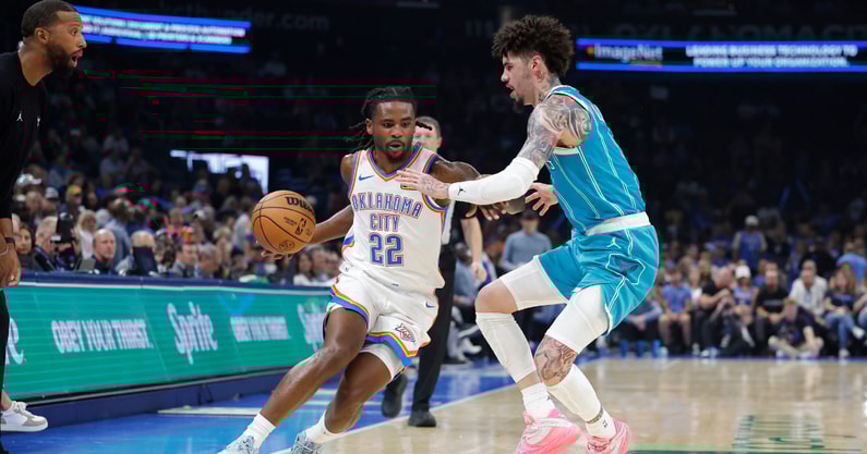 Oct 9, 2025; Oklahoma City, Oklahoma, USA; Oklahoma City Thunder guard Cason Wallace (22) drives around Charlotte Hornets guard Lamelo Ball (1) during the second quarter of a game between the Charlotte Hornets and the Oklahoma City Thunder at Paycom Center. Mandatory Credit: Alonzo Adams-Imagn Images