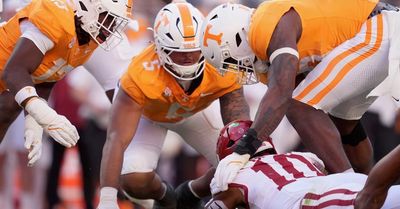Saul Young/News Sentinel / USA TODAY NETWORK via Imagn Images | Tennessee linebacker Edwin Spillman (13), defensive lineman Daevin Hobbs (5), and defensive lineman Joshua Josephs (19) chase after a fumbled ball by Arkansas quarterback Taylen Green (10) in an NCAA college football game on Oct. 11, 2025, in Knoxville, Tennessee.