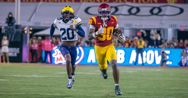 USC running back King Miller runs away from a Michigan defender