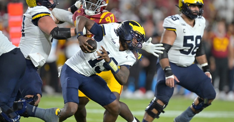 Oct 11, 2025; Los Angeles, California, USA; Michigan Wolverines quarterback Bryce Underwood (19) is pressured in the pocket in the second half against the USC Trojans at United Airlines Field at the Los Angeles Memorial Coliseum. Mandatory Credit: Jayne Kamin-Oncea-Imagn Images