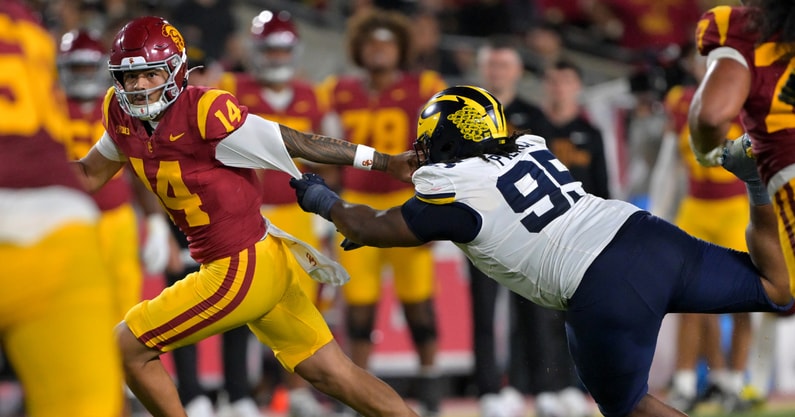 USC quarterback Jayden Maiava evading Michigan DT Trey Pierce. (Photo by Jayne Kamin-Oncea-Imagn Images)