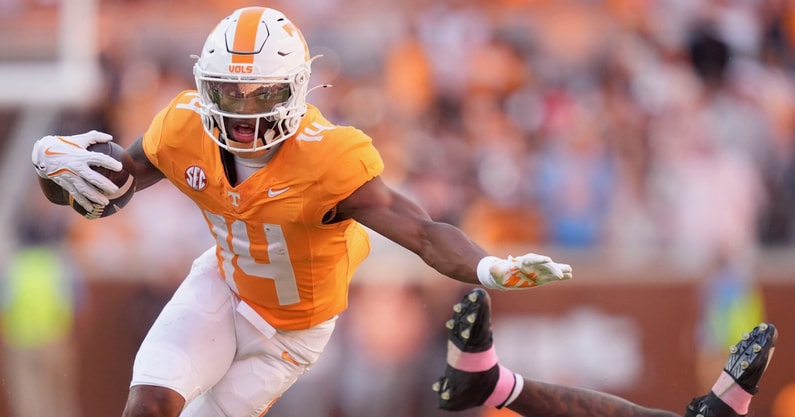 Saul Young/News Sentinel / USA TODAY NETWORK via Imagn Images | Tennessee wide receiver Braylon Staley (14) keeps going after breaking a tackle from Arkansas defensive back Miguel Mitchell (16) in an NCAA college football game on Oct. 11, 2025, in Knoxville, Tennessee.