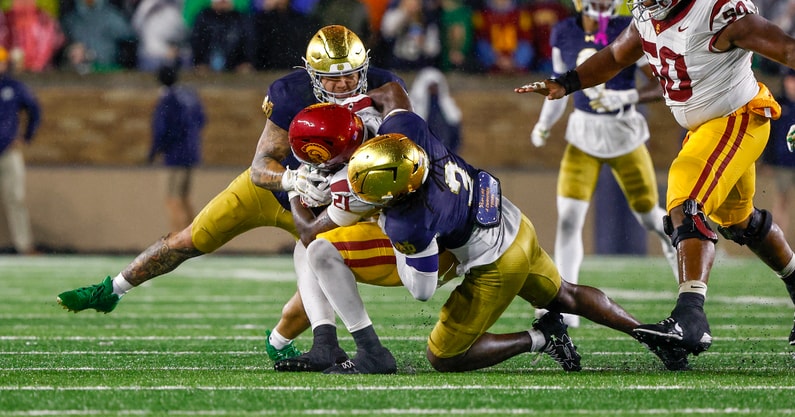 Notre Dame defenders Jaylen Sneed and Jordan Botelho USC