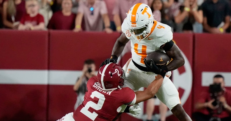 Oct 18, 2025; Tuscaloosa, Alabama, USA; Tennessee Volunteers wide receiver Mike Matthews (4) runs with the ball while being defended by Alabama Crimson Tide defensive back Zabien Brown (2) at Saban Field at Bryant-Denny Stadium. Mandatory Credit: Gary Cosby-USA TODAY Network via Imagn Images