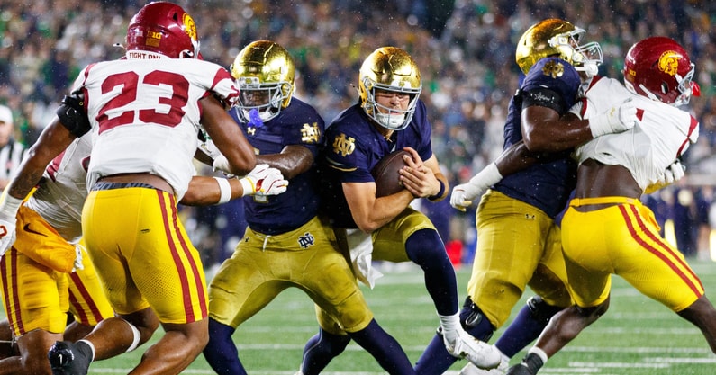 Notre Dame quarterback CJ Carr, center, runs with the ball in the second half of a NCAA football game against USC at Notre Dame Stadium on Saturday, Oct. 18, 2025, in South Bend