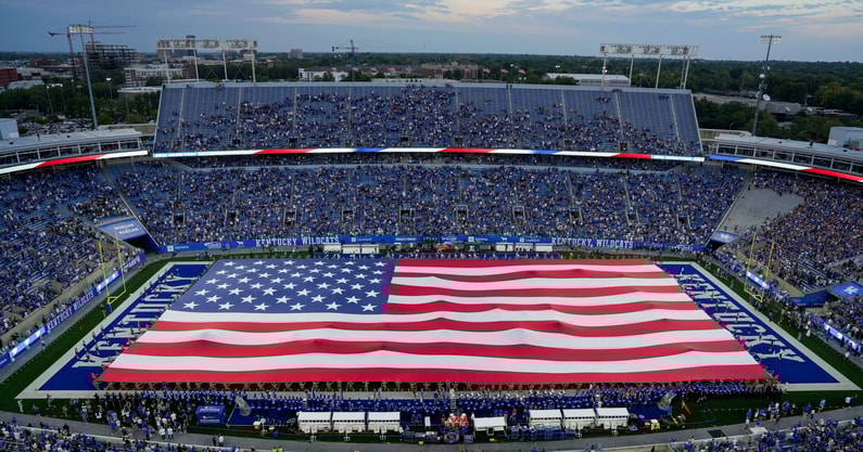 Matt Stone/Courier Journal / USA TODAY NETWORK via Imagn Images | The American flag carried by UK's ROTC covered the football field before the national anthem as the Kentucky Wildcats play Eastern Michigan at Kroger Field in Lexington, Kentucky Saturday, Sept. 13, 2025.