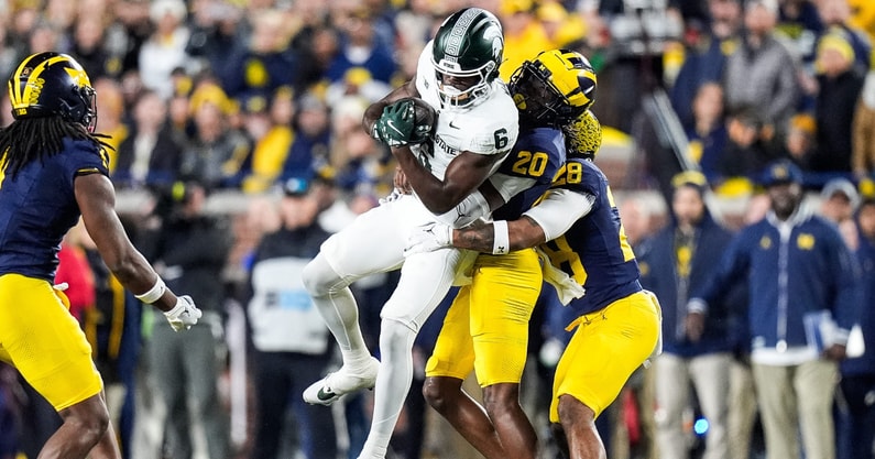 Michigan State wide receiver Nick Marsh (6) makes a catch against Michigan defensive backs Jyaire Hill (20) and Quinten Johnson (28) during the first half at Michigan Stadium in Ann Arbor. - Junfu Han, USA TODAY Sports