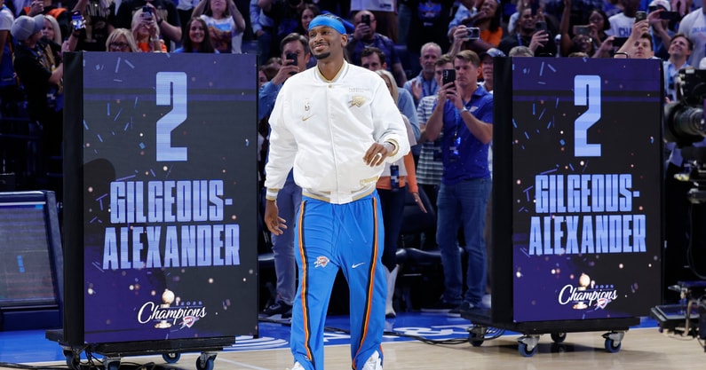 Oct 21, 2025; Oklahoma City, Oklahoma, USA; Oklahoma City Thunder guard Shai Gilgeous-Alexander walks onto the court during the championship ring and banner ceremony before the start of their game against the Houston Rockets at Paycom Center. Mandatory Credit: Alonzo Adams-Imagn Images