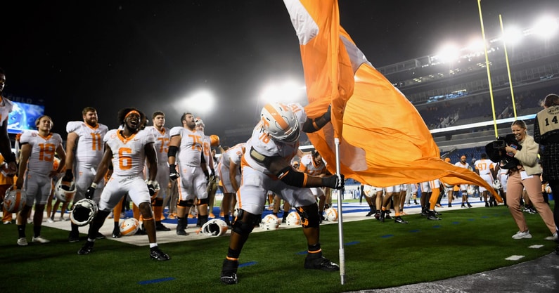 Caitie McMekin/News Sentinel / USA TODAY NETWORK | Tennessee offensive lineman Javontez Spraggins (76) plants the Tennessee flag after a football game between Kentucky and Tennessee at Kroger Field in Lexington, Kentucky, Saturday, Oct. 28, 2023. Tennessee defeated Kentucky.