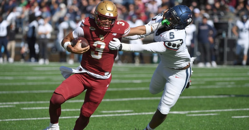 Oct 18, 2025; Chestnut Hill, Massachusetts, USA; Boston College Eagles quarterback Grayson James (3) stiff arms UConn Huskies linebacker Aaron Key (5) during the first half at Alumni Stadium. Mandatory Credit: Bob DeChiara-Imagn Images
