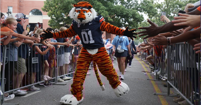 Sep 6, 2025; Auburn, Alabama, USA; Aubie, the Auburn Tigers mascot, greets fans as he goes through Tiger Walk before the game against the Ball State Cardinals at Jordan-Hare Stadium. Mandatory Credit: John Reed-Imagn Images