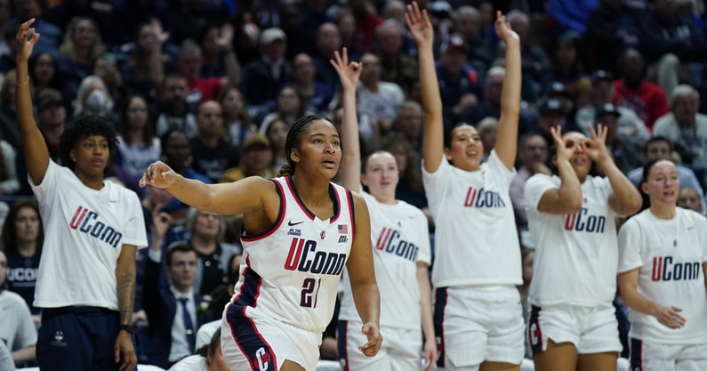 UConn's bench celebrates a three-pointer