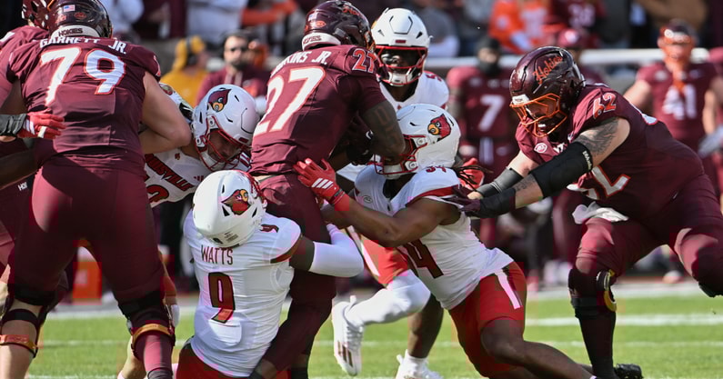 Nov 1, 2025; Blacksburg, Virginia, USA; Louisville Cardinals defensive back Antonio Watts (9) tackles Virginia Tech Hokies running back Marcellous Hawkins (27) during the first quarter at Lane Stadium. Mandatory Credit: Brian Bishop-Imagn Images
