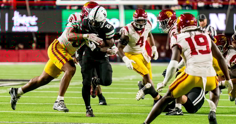 Nebraska running back Emmett Johnson (21) runs against USC Trojans defensive tackle Devan Thompkins (8) during the fourth quarter at Memorial Stadium
