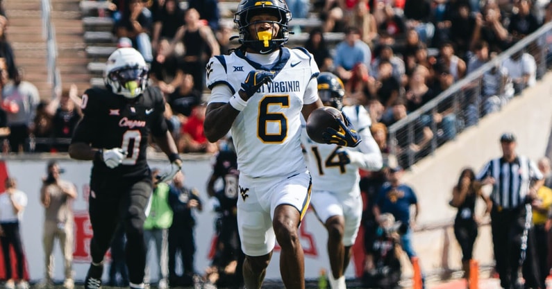 West Virginia defensive back Jordan Scruggs returns the pick-six against Houston