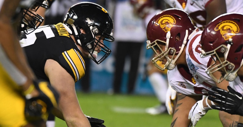 Iowa Hawkeyes offensive lineman Tyler Linderbaum (65) snaps the ball against the USC Trojans during the Holiday Bowl at SDCCU Stadium