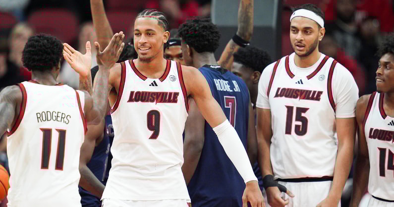 Louisville Cardinals forward Khani Rooths (9) smiles as he draws the foul as Louisville Cardinals guard Kobe Rodgers (11) celebrates as the Cards are rolling past South Carolina State 71-17 in the second half at the KFC Yum! Center Monday night, Nov. 3, 2025.