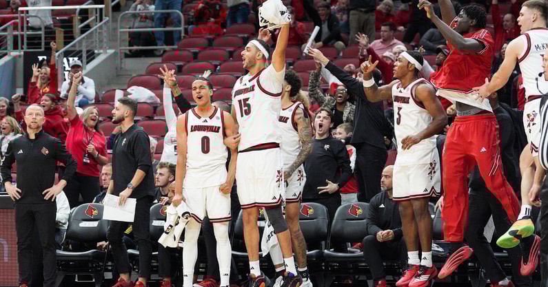 The Cards bench erupts in cheers after Louisville Cardinals guard Cole Sherman (4) hit a three point shot late in the second half as the Cards roll past South Carolina State 104-45 at the KFC Yum! Center Monday night, Nov. 3, 2025.