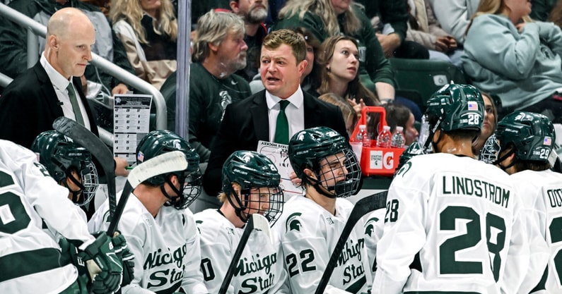 Michigan State's head coach Adam Nightingale, center, talks with the team during a break in the action in the first period of the game against New Hampshire on Thursday, Oct. 9, 2025. - Nick King, USA TODAY Sports