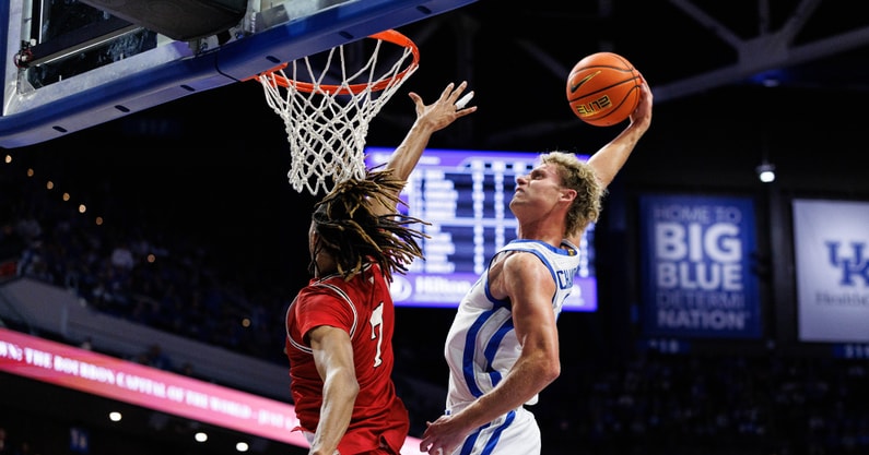 Nov 4, 2025; Lexington, Kentucky, USA; Kentucky Wildcats guard Collin Chandler (5) dunks the ball over Nicholls Colonels forward Grant Sanders (7) during the second half at Rupp Arena at Central Bank Center. Mandatory Credit: Jordan Prather-Imagn Images