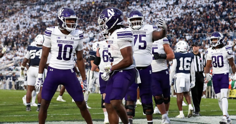Northwestern Wildcats wide receiver Ricky Ahumaraeze (10) and offensive lineman Martes Lewis (75) celebrate with running back Caleb Komolafe (5) after scoring a touchdown during the fourth quarter against the Penn State Nittany Lions at Beaver Stadium
