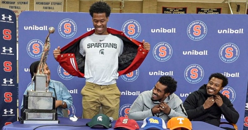 Stepinac High School basketball star Jasiah Jervis unveils a Michigan State University t-shirt as he announces which college he will be attending and playing basketball. - Seth Harrison, USA TODAY Sports