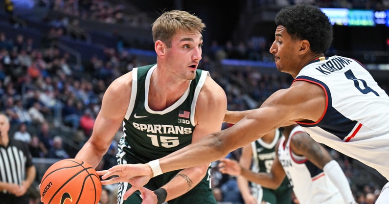 Connecticut Huskies forward Dwayne Koroma (4) knocks the ball away from Michigan State Spartans center Carson Cooper (15) during the second half at PeoplesBank Arena. - Mark Smith, USA TODAY Sports