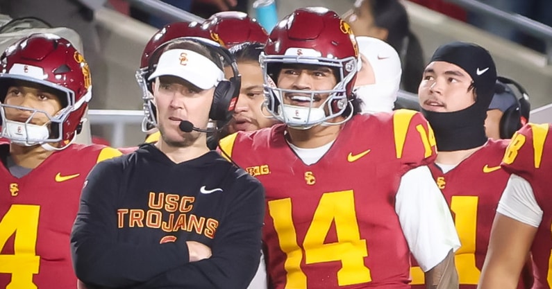 USC head coach Lincoln Riley and quarterback Jayden Maiava look on from the sideline during a game against Northwestern