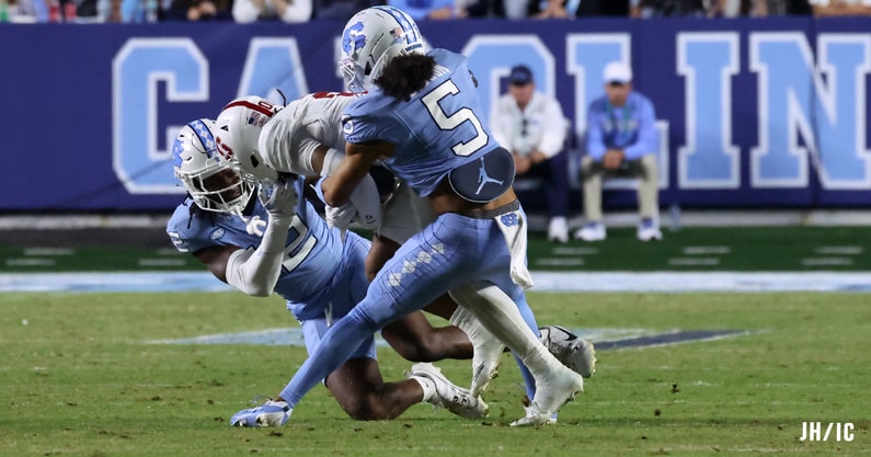 Gavin Gibson and Greg Smith make a tackle against Stanford.