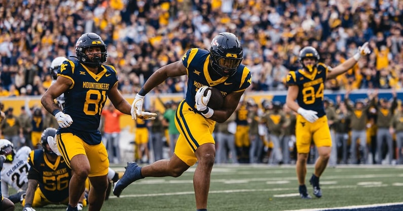 West Virginia's Curtis Jones scores the touchdown against Colorado